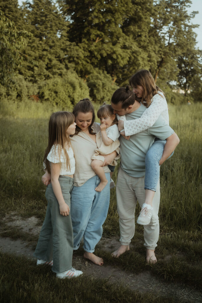 Familie steht zusammen in der Natur Familienfotografie in Berlin & Brandenburg