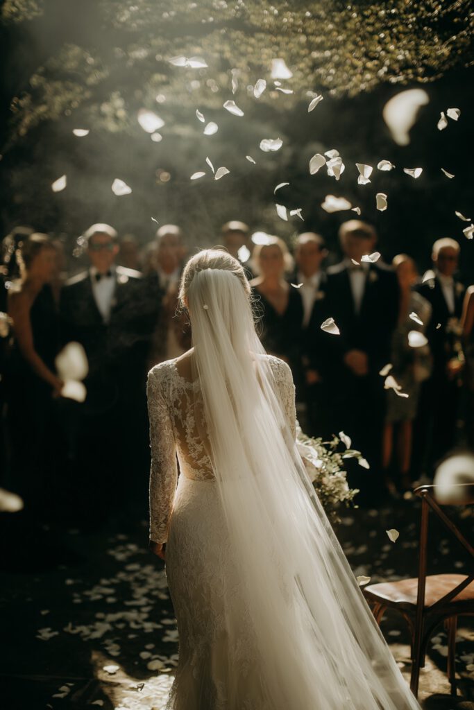 Braut mit Schleier läuft auf Gäste zu