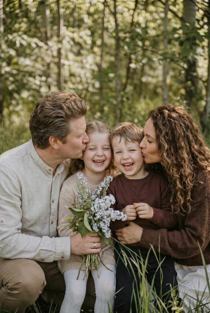 Eltern mit zwei Kindern in der Natur mit Blumenstrauß